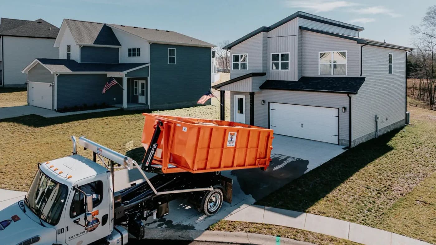 Underdog Dumpster roll-off truck placing a dumpster outside a Clarksville home